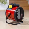 A red electric heater with a black stand is placed on a light-colored wooden floor. Náhled obrázku produktu