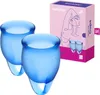 A product shot of two blue menstrual cups and their packaging. Náhled obrázku produktu