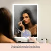 A woman is applying makeup in front of a lighted mirror with fog-resistant function. Produktbild-Vorschau