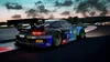 A racing car on a track at dusk. Produktbild-Vorschau