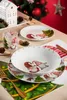 A Christmas-themed table setting with plates, a bowl, and a glass decorated with gnomes and Christmas trees. Anteprima dell’immagine prodotto
