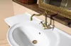 A close-up view of a vintage-style bronze faucet and sink. Anteprima dell’immagine prodotto