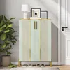 A light green shoe cabinet with gold accents is shown in a hallway next to a potted plant and a white door. Produktbild-Vorschau