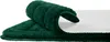 A close-up view of a dark green bath mat, showing its textured surface and backing. Náhled obrázku produktu