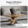 A modern living room setting with a couch and a coffee table. Produktbild-Vorschau