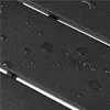 A close-up view of a black textured surface with water droplets on it, showing parallel lines suggesting a slatted design. Produktbild-Vorschau