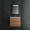 A modern bathroom vanity with a sink and mirror against a dark tiled wall. Produktbild-Vorschau