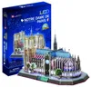 A 3D puzzle model of Notre Dame Cathedral with LED lighting, displayed next to its packaging. Produktbild-Vorschau
