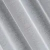 A close-up view of white fabric with a textured, ribbed pattern, showing folds and creases. Produktbild-Vorschau