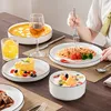 A table setting with a meal and dessert, with a person eating. Voir les images du produit