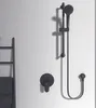 A black shower fixture set mounted on a white wall, with a towel rack and towels to the left. Produktbild-Vorschau