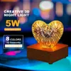 A heart-shaped 3D night light with a fireworks effect, displayed on a wooden base. Produktbild-Vorschau