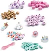 A collection of colorful beads and charms for jewelry making, arranged on a white background. Anteprima dell’immagine prodotto