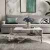 A modern living room scene with a couch, coffee table, and artwork. Produktbild-Vorschau