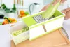 A person is using a multi-functional grater to shred a zucchini over a container in a kitchen setting. Produktbild-Vorschau