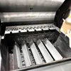 Inside view of a grill with metal heat shields installed. Podgląd zdjęcia produktu