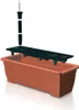 A planter box with a water reservoir system and a water level indicator, shown in an exploded view. Anteprima dell’immagine prodotto
