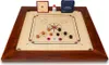 A carrom board game set up with pieces on the board, along with accessories. Náhled obrázku produktu