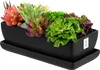 A black ceramic rectangular planter filled with various artificial succulents, placed on a matching black saucer. Produktbild-Vorschau
