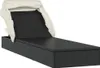 A black poly rattan sun lounger with a cream canopy, shown from a side-diagonal angle on a white background. Náhled obrázku produktu