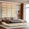 A bedroom setting with a large upholstered headboard and bed. Anteprima dell’immagine prodotto