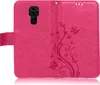 A pink flip case for a Xiaomi Redmi Note 9 phone, with a floral and butterfly embossed design. Produktbild-Vorschau