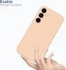 A hand holding a peach-colored phone case against a white background. Produktbild-Vorschau