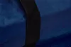 A close-up view of a blue fabric with a black strap. Produktbild-Vorschau