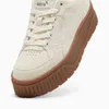 A close-up view of a beige Puma sneaker with a brown sole. Produktbild-Vorschau