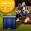 A couple sitting by a campfire with a cooler in the foreground. Podgląd zdjęcia produktu