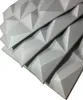 A stack of grey 3D wall panels with a geometric pattern. Produktbild-Vorschau