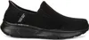 A side view of a black Skechers slip-on shoe. Voir les images du produit