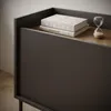 A close-up view of a modern TV cabinet with books and an hourglass on top. Produktbild-Vorschau