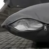 Close-up of a gray cushion with an open zipper, revealing white filling. Produktbild-Vorschau