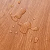 Water droplets on a wood-grain surface. Anteprima dell’immagine prodotto