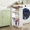 A slim storage cart filled with cleaning supplies and toiletries is placed next to a washing machine in a laundry room. Anteprima dell’immagine prodotto