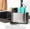 A kitchen sink area with a dish soap dispenser and brush holder. Anteprima dell’immagine prodotto