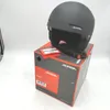 A black Alpina Zupo ski helmet is placed on top of its original packaging box. Voir les images du produit