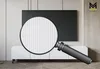 A TV lowboard with a large magnifying glass in front of it, highlighting the texture of the cabinet doors. A logo is visible in the top right corner. Podgląd zdjęcia produktu