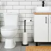 A modern bathroom scene featuring a toilet, a toilet paper holder, and a vanity with a sink. Podgląd zdjęcia produktu