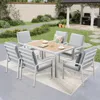 An outdoor dining set with chairs and a table on a patio with a garden in the background. Produktbild-Vorschau