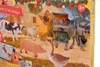A close-up view of a farm-themed advent calendar with various animal figurines. Podgląd zdjęcia produktu