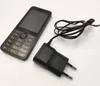 A Nokia feature phone and its charger are placed on a white surface. Podgląd zdjęcia produktu