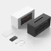 A black humidifier with a fireplace flame effect and a white box are displayed on a white background, along with a remote control and a charging cable. Náhľad obrázku produktu