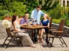 A family enjoying a meal outdoors at a garden table. Anteprima dell’immagine prodotto