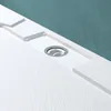 A close-up view of a white shower drain assembly set into a textured white shower tray, with a teal wall in the background. Produktbild-Vorschau