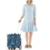 A woman stands next to a shopping trolley. Produktbild-Vorschau