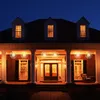 A house porch decorated with starburst lights at night. Produktbild-Vorschau