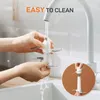 Hands washing the blades of an electric food chopper under running water from a faucet. Produktbild-Vorschau