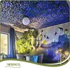 A room decorated with 3D wall panels on the ceiling and a mural on the wall, featuring furniture and plants. Podgląd zdjęcia produktu